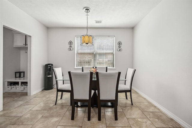 dining space featuring visible vents, baseboards, and light tile patterned flooring