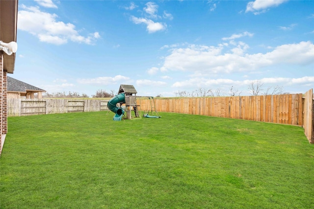 view of yard featuring a fenced backyard and a playground