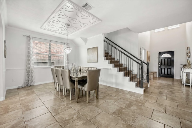 dining area with a chandelier, visible vents, baseboards, stairs, and crown molding