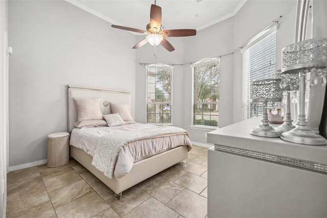 bedroom with light tile patterned floors, ceiling fan, baseboards, and ornamental molding