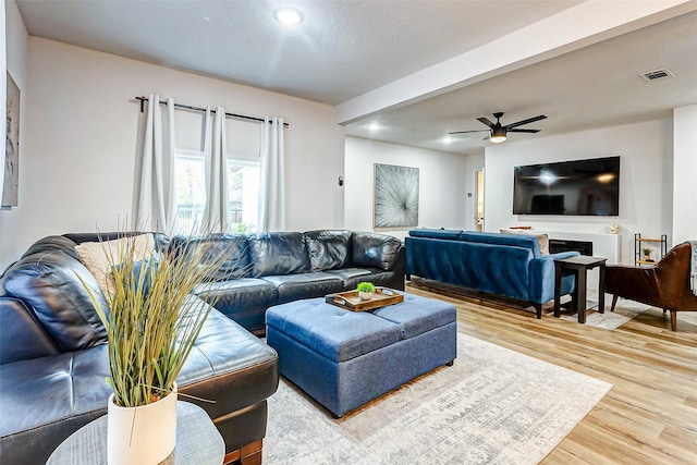 living room with hardwood / wood-style flooring and ceiling fan