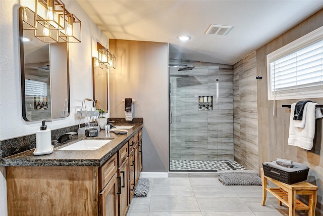 bathroom featuring vanity, a shower with shower door, and tile patterned flooring