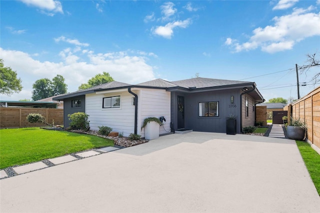 single story home with a front yard and a patio