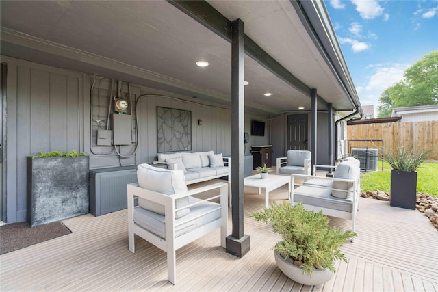 wooden terrace featuring central AC, an outdoor living space, and electric panel