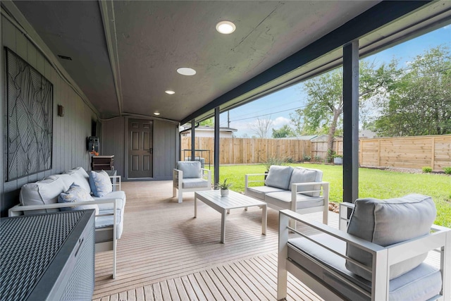 wooden terrace featuring an outdoor living space and a yard