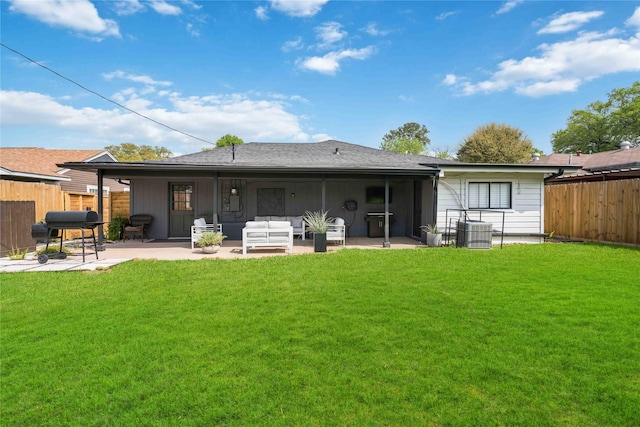 back of property with cooling unit, a yard, an outdoor hangout area, and a patio