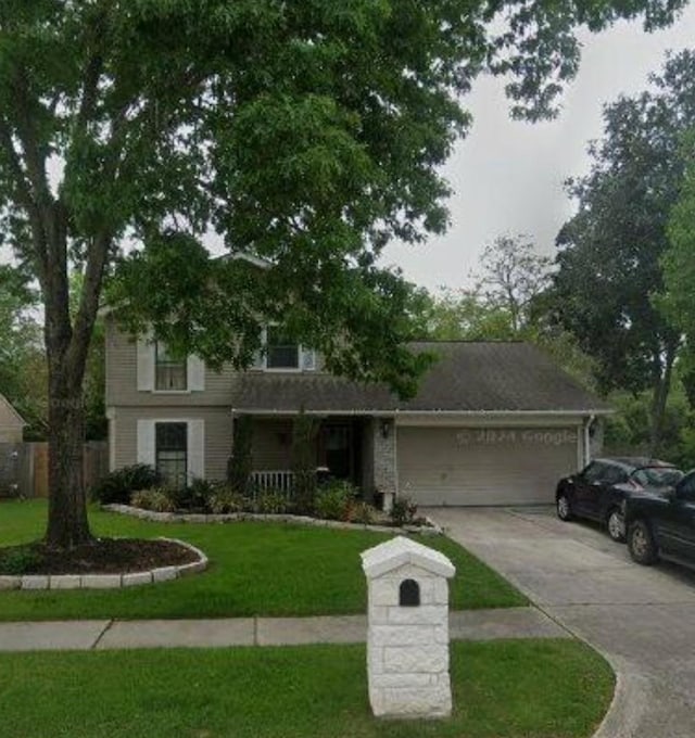 view of front of property featuring a garage and a front lawn