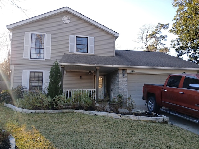 view of front property with a garage, a front yard, and a porch