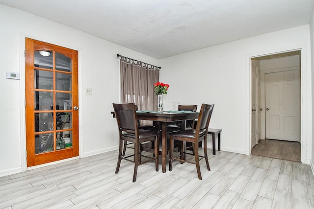 dining space with light wood-type flooring