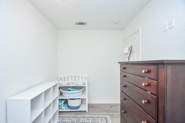 walk in closet featuring light hardwood / wood-style flooring