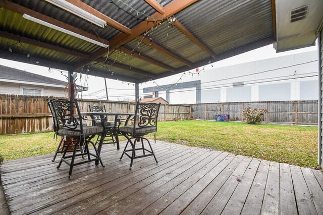 wooden terrace featuring a yard