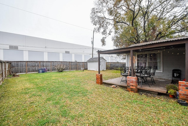 view of yard with a storage shed and a deck