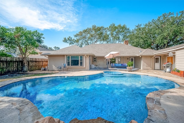 view of swimming pool with an in ground hot tub, area for grilling, an outdoor hangout area, and a patio