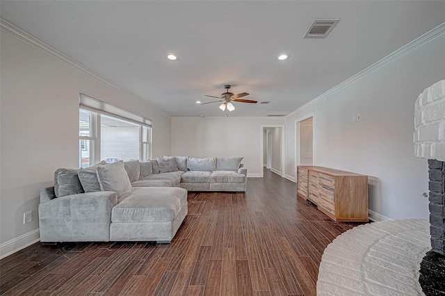 living room with dark wood-type flooring, ceiling fan, and crown molding