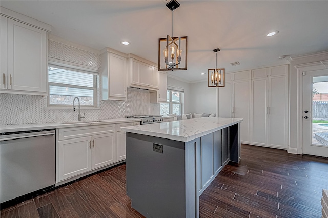 kitchen with a kitchen island, white cabinetry, dishwasher, sink, and hanging light fixtures