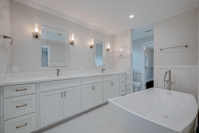 bathroom featuring vanity, a bathtub, ornamental molding, and toilet