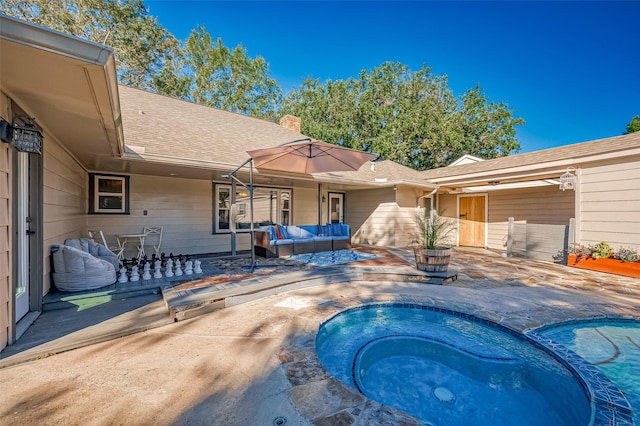 view of pool featuring an in ground hot tub, an outdoor hangout area, and a patio area