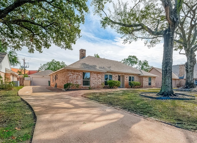 ranch-style home with a garage and a front yard