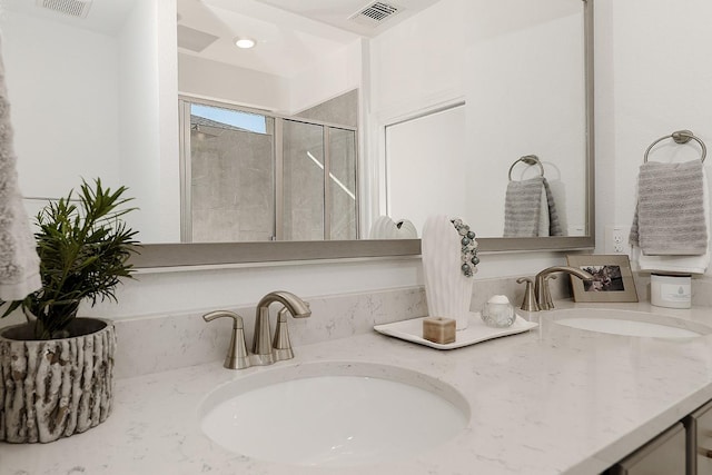 bathroom featuring vanity and a shower with shower door