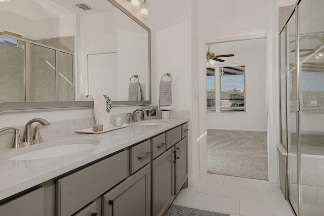 bathroom with ceiling fan, tile patterned floors, vanity, and an enclosed shower