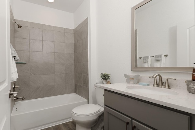 full bathroom with tiled shower / bath, vanity, toilet, and wood-type flooring