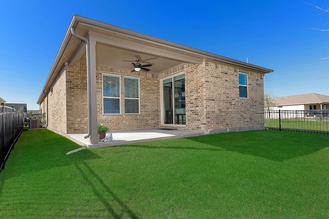 rear view of property featuring central air condition unit, a patio area, ceiling fan, and a lawn