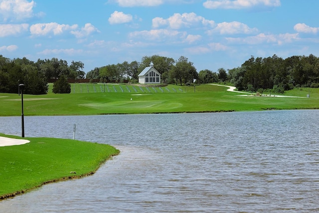 surrounding community with a yard and a water view