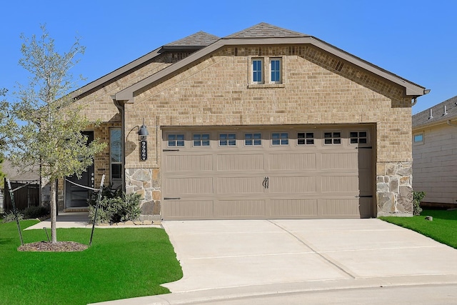 view of front of home with a garage and a front lawn