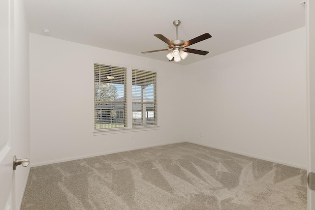 spare room with carpet floors and ceiling fan