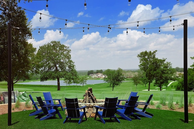 view of property's community with a yard and a water view