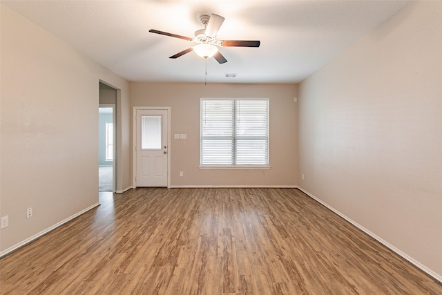 empty room featuring hardwood / wood-style flooring and ceiling fan