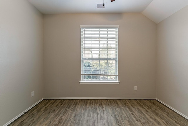 empty room with ceiling fan, wood-type flooring, and vaulted ceiling