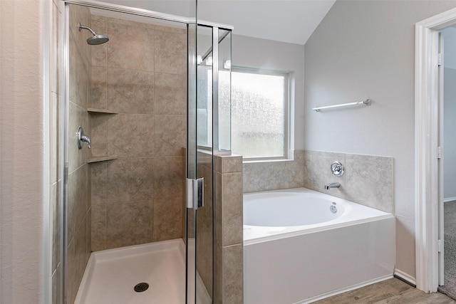 bathroom featuring wood-type flooring and shower with separate bathtub