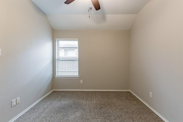 carpeted spare room with ceiling fan and vaulted ceiling