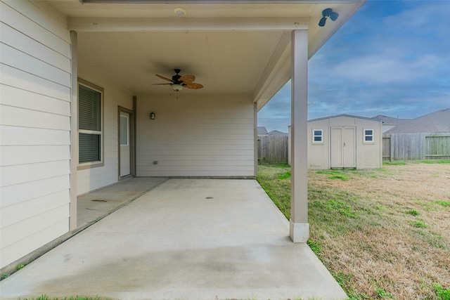 view of patio / terrace with ceiling fan and a storage unit