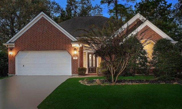 front of property with a garage and a front lawn