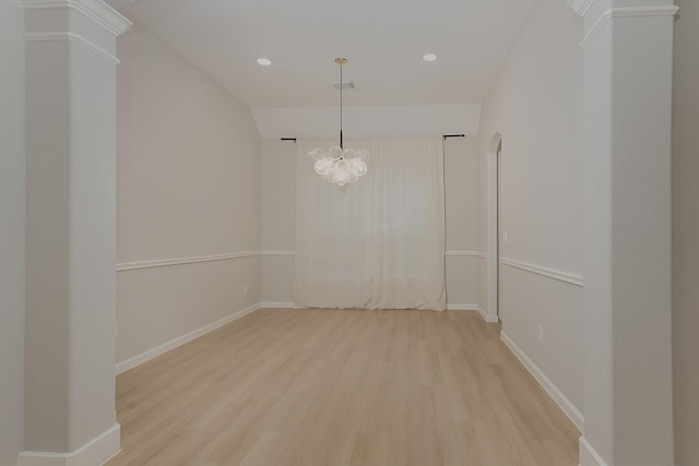 unfurnished room featuring hardwood / wood-style floors and ornate columns