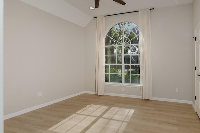 interior space with ceiling fan, lofted ceiling, and light wood-type flooring