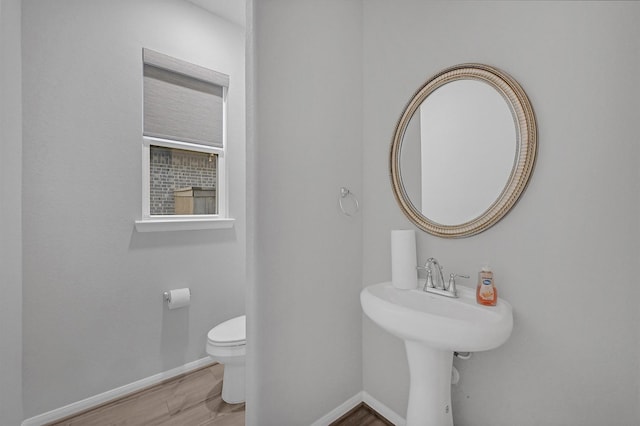 bathroom featuring hardwood / wood-style floors and toilet