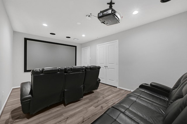 home theater room featuring light wood-type flooring