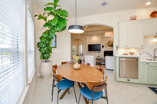 dining space featuring sink, a wealth of natural light, and light tile patterned flooring