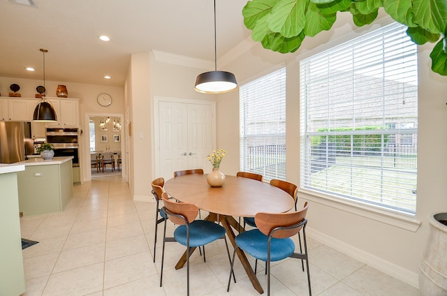 dining area featuring light tile patterned floors and ornamental molding