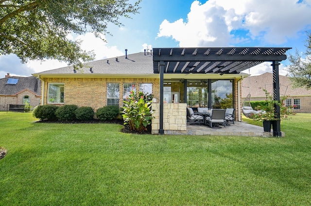 back of property with a pergola, a lawn, and a patio