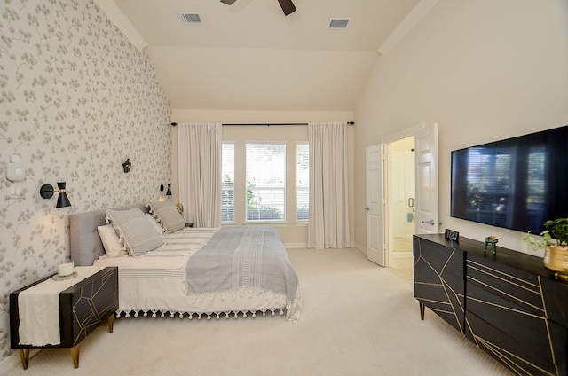 carpeted bedroom featuring connected bathroom, vaulted ceiling, and ceiling fan