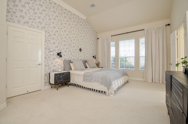 bedroom featuring light carpet, crown molding, and lofted ceiling