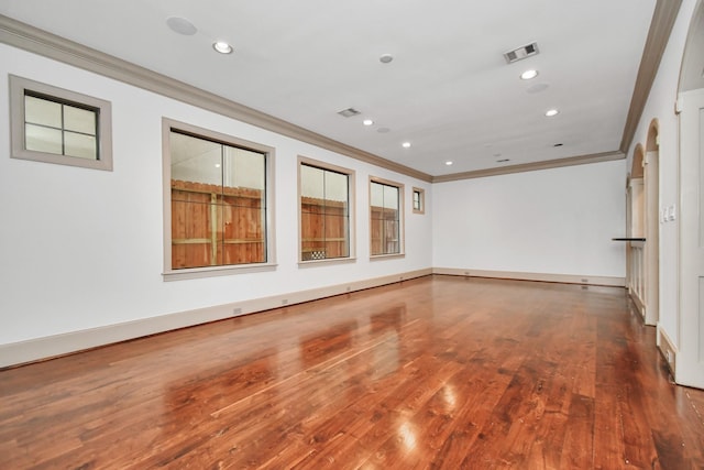 unfurnished room featuring ornamental molding and hardwood / wood-style floors