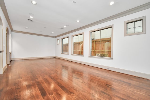 unfurnished room featuring crown molding and wood-type flooring