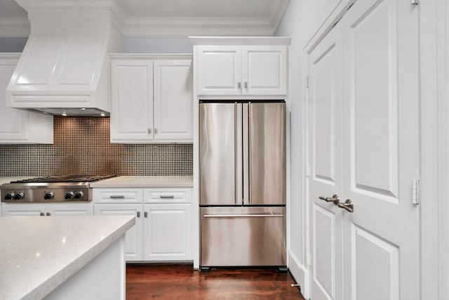 kitchen with premium range hood, white cabinetry, and appliances with stainless steel finishes