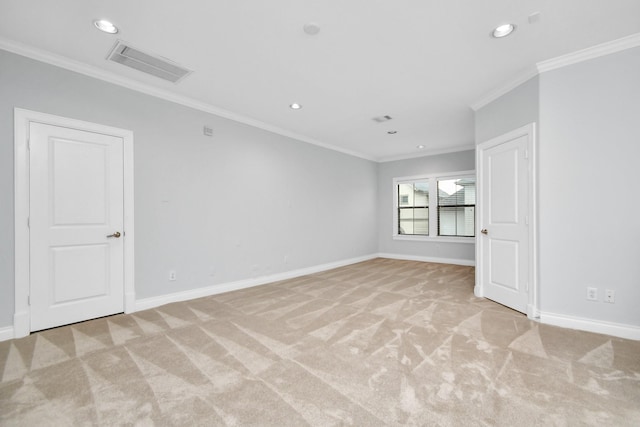 carpeted spare room featuring ornamental molding