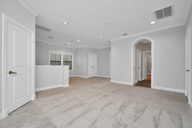 unfurnished room with crown molding and light colored carpet